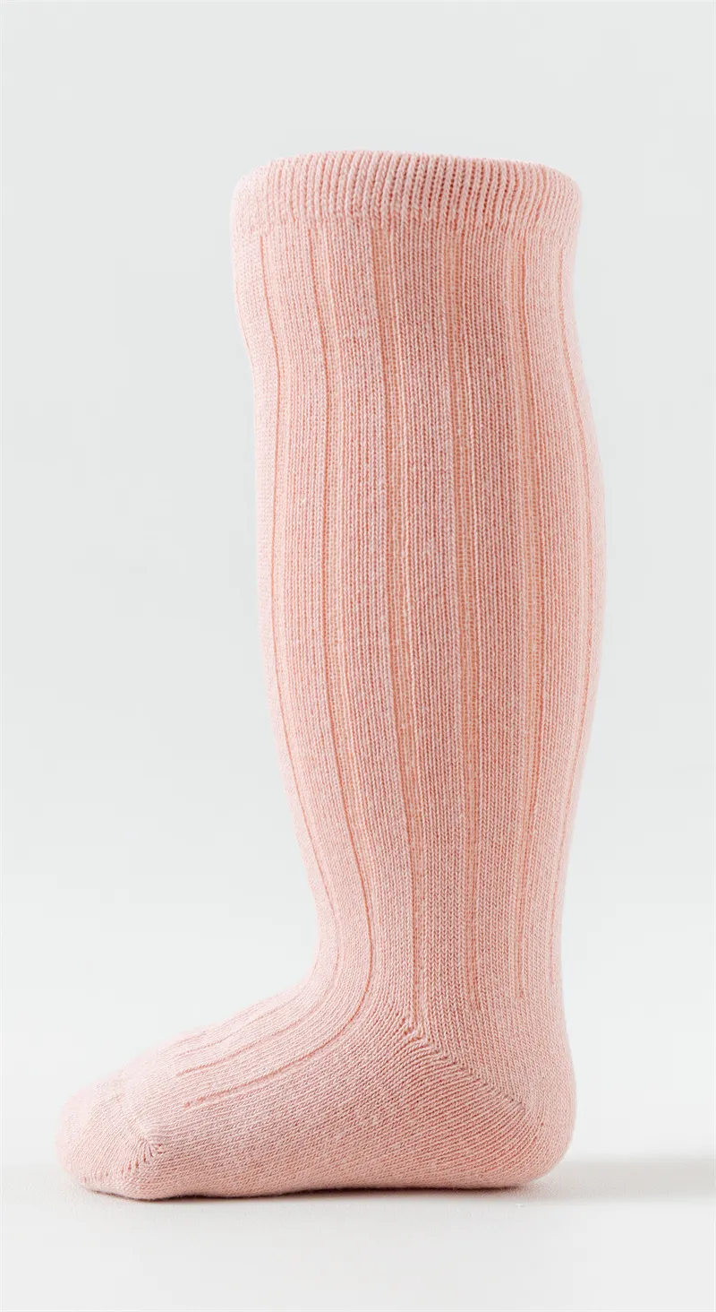 Baby girls knee high basic cotton socks in pink displayed on a foot model. Baby girls knee high basic cotton socks in pink displayed on a foot model.