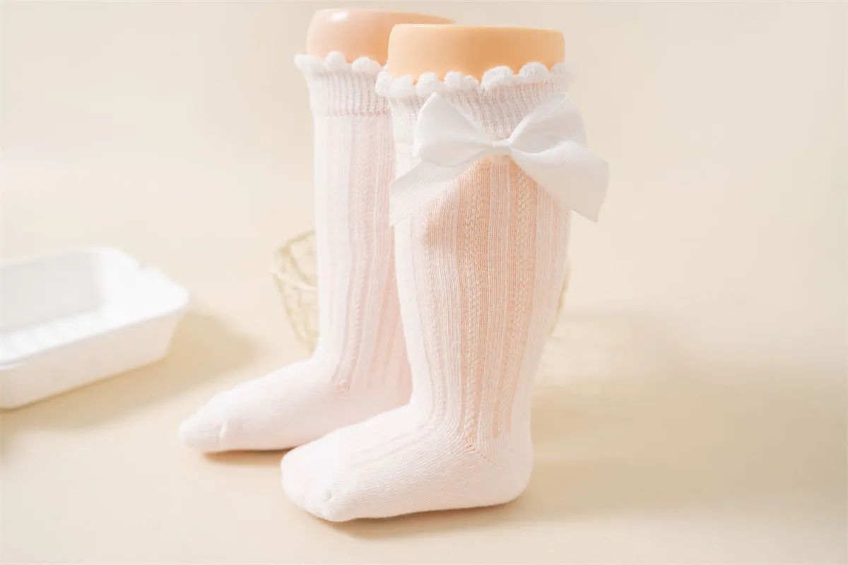 Baby girl wearing knee high bow socks Baby girl wearing knee high bow socks