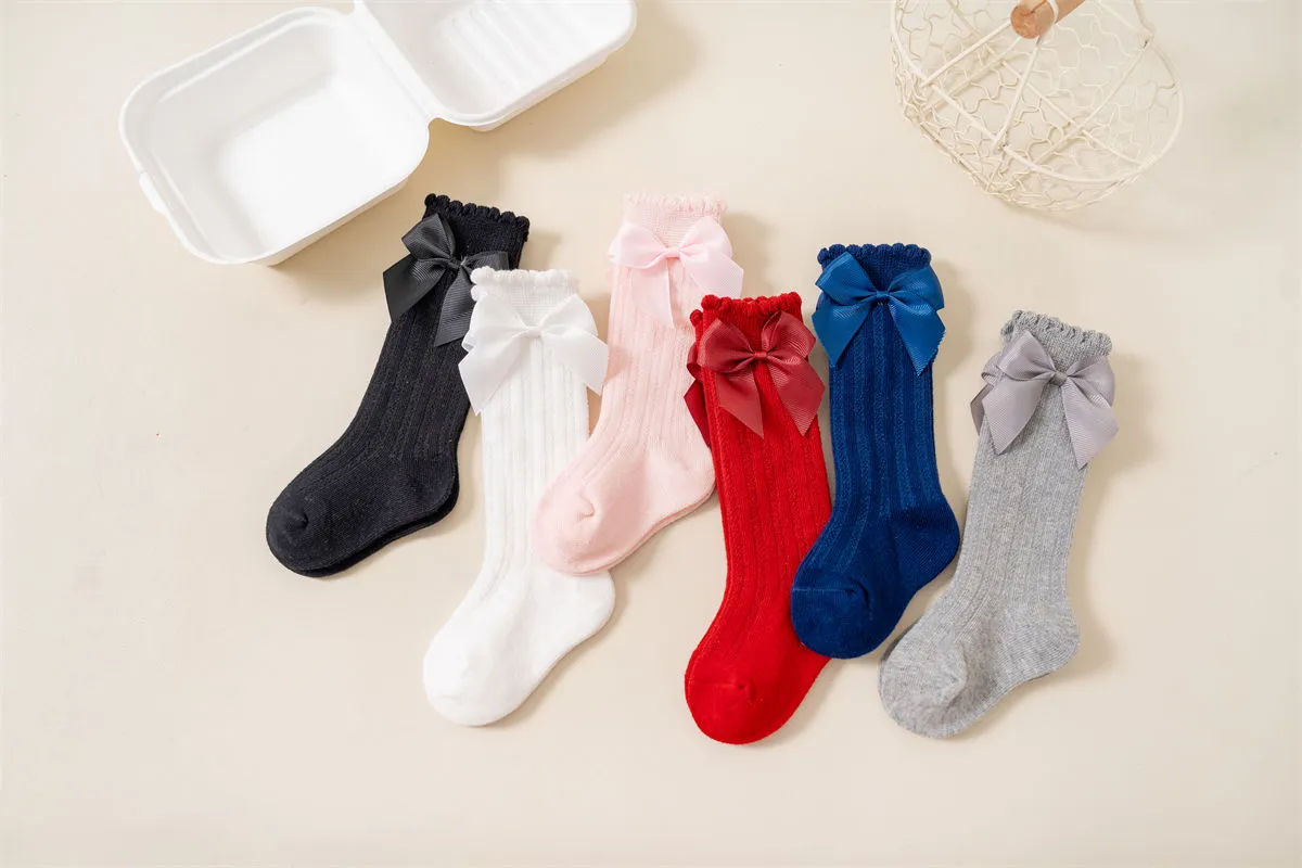 Baby girls knee high bow socks available in multiple colors Baby girls knee high bow socks available in multiple colors