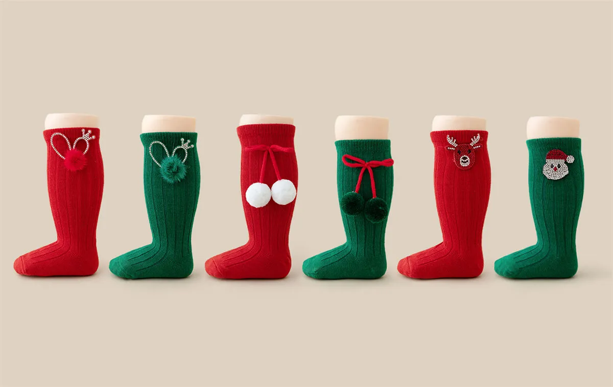 Wholesale rhinestone Christmas baby girls socks with Santa, reindeer and pom pom designs.