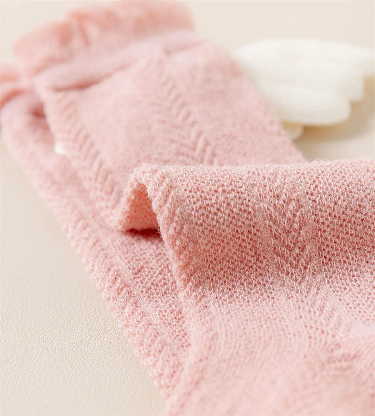 Soft cotton knitted texture detail of pink baby knee high socks. Soft cotton knitted texture detail of pink baby knee high socks.