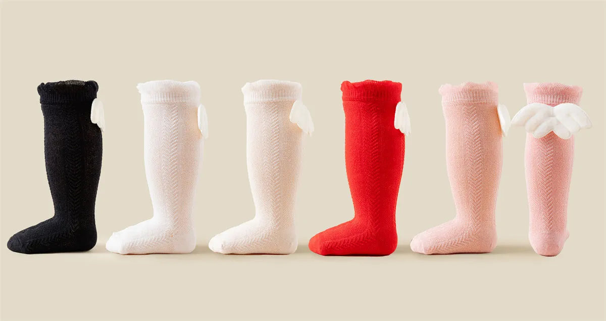 Wholesale baby girls knee high socks with angel wings in black, white, red and pink. Wholesale baby girls knee high socks with angel wings in black, white, red and pink.